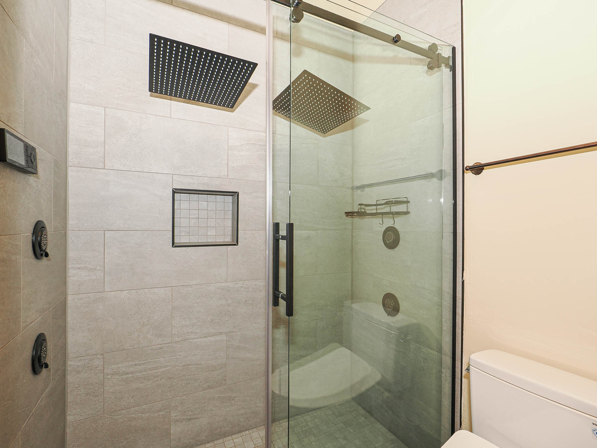 Bathroom featuring toilet and a stall shower
