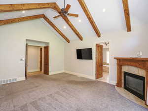 Unfurnished living room featuring recessed lighting, light colored carpet, a fireplace, and a ceiling fan