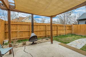 Fenced backyard featuring a patio and an outdoor fire pit