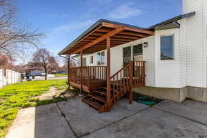 Entrance to property featuring a patio area and a yard