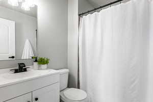 Full bathroom featuring vanity and a shower with shower curtain
