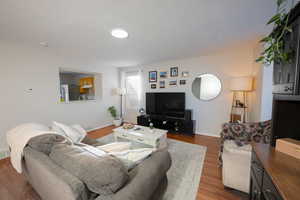 Living area featuring baseboards and wood finished floors