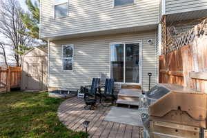 Wooden deck with a grill and a storage unit