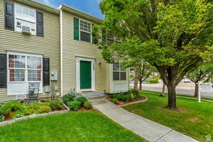 Colonial home featuring a front lawn