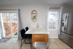 Dining space featuring light tile patterned floors