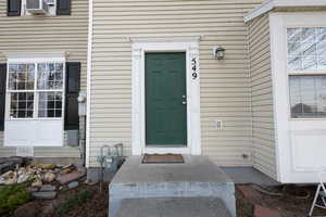 Doorway to property featuring cooling unit