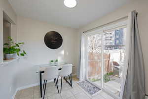 Dining area featuring baseboards and light tile patterned flooring