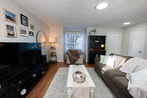Living area featuring wood finished floors and a textured ceiling