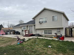 View of front of home with a patio area and a front lawn