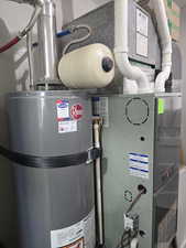 Utility room with water heater and heating unit