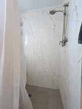Bathroom with a marble finish shower