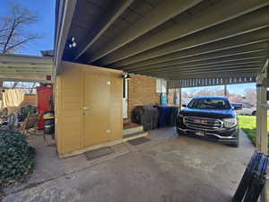 Garage featuring a carport