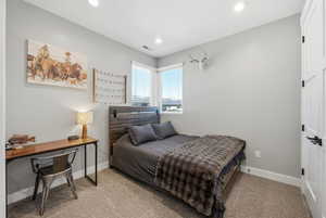 Bedroom featuring light colored carpet and recessed lighting