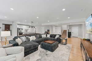 Living area with light wood-style floors, recessed lighting, billiards table, and a textured ceiling