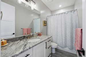Bathroom featuring vanity and shower / tub combo with curtain