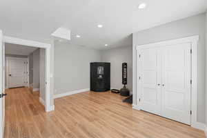Game room with light wood finished floors, recessed lighting, and a textured ceiling