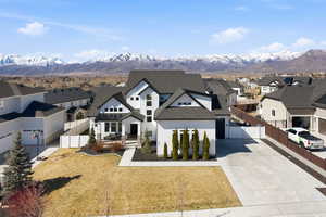 Modern farmhouse style home with a residential view, a mountain view, and a gate