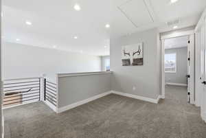 Corridor featuring carpet, an upstairs landing, and recessed lighting