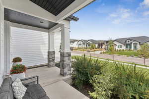 Covered porch featuring a residential view