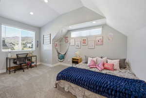 Bedroom with light colored carpet, a desk, and recessed lighting