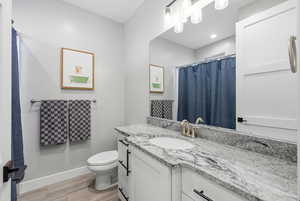 Bathroom featuring vanity, a shower with curtain, and light wood-style floors