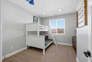 Bedroom featuring light colored carpet and recessed lighting