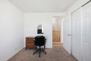 Unfurnished office with carpet flooring and baseboards