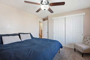 Bedroom featuring carpet floors, a ceiling fan, and a closet