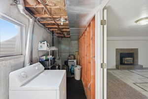 Laundry area featuring washer / dryer and a fireplace