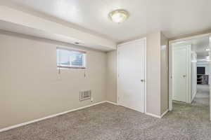 Unfurnished bedroom with carpet flooring and a textured ceiling