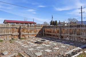 Fenced backyard with an outdoor fire pit