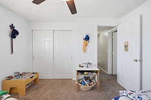 Bedroom featuring carpet flooring, a closet, and ceiling fan