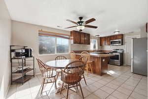Dining room featuring light tile patterned floors and a ceiling fan