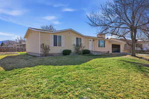 View of front of home featuring an attached garage and a chimney
