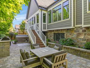 Paver patio with an integrated built-in grill station and a tiered planter wall