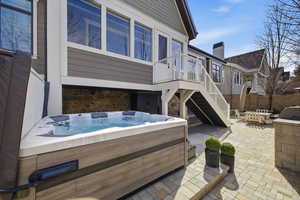 View of patio / terrace with outdoor dining area and a hot tub