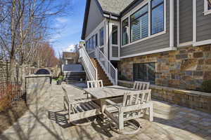 View of patio / terrace featuring outdoor dining space and stairway