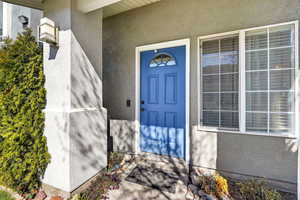 Entrance to property with stucco siding