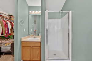 Bathroom with vanity and a stall shower