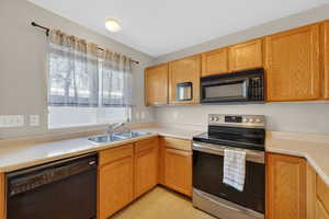 Kitchen with black appliances and light countertops