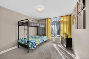 Bedroom featuring baseboards and carpet flooring