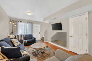 Living room with stairway and wood finished floors