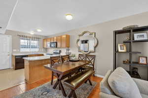 Dining space featuring light wood-type flooring and baseboards