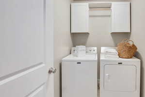 Laundry room with washing machine and dryer and cabinet space