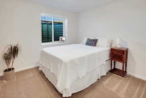 Bedroom with light colored carpet