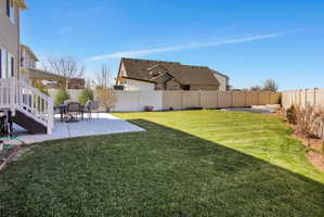 Fenced backyard with a patio