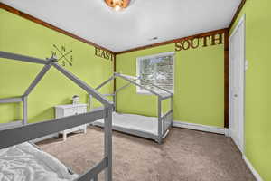 Carpeted bedroom featuring a closet, a baseboard radiator, and a textured ceiling