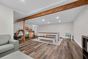 Living area featuring wood finished floors, recessed lighting, and beamed ceiling
