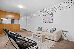 Living room featuring light carpet and a textured ceiling