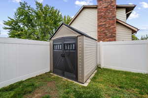 View of shed featuring a fenced backyard